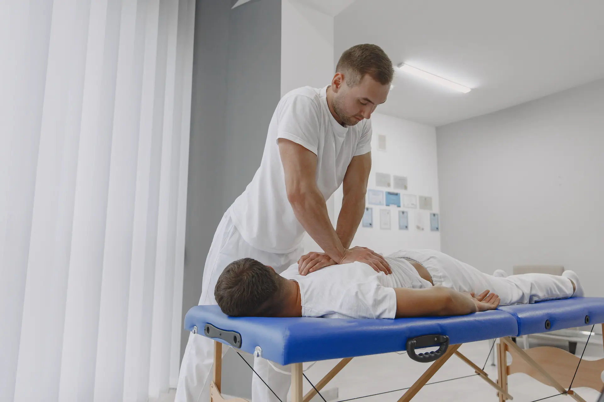 Chiropractor performing precision cervical alignment and muscle release on patient
